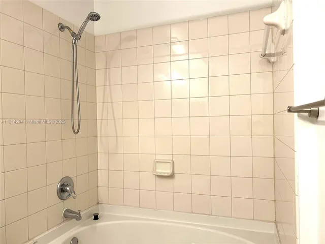 a bathroom with a bathtub and shower