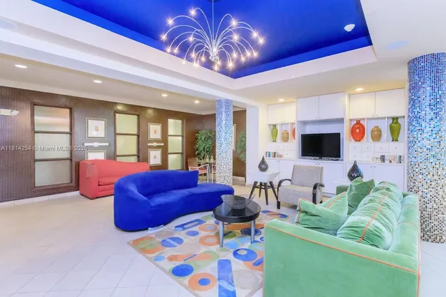 a living room with furniture and a floor to ceiling window