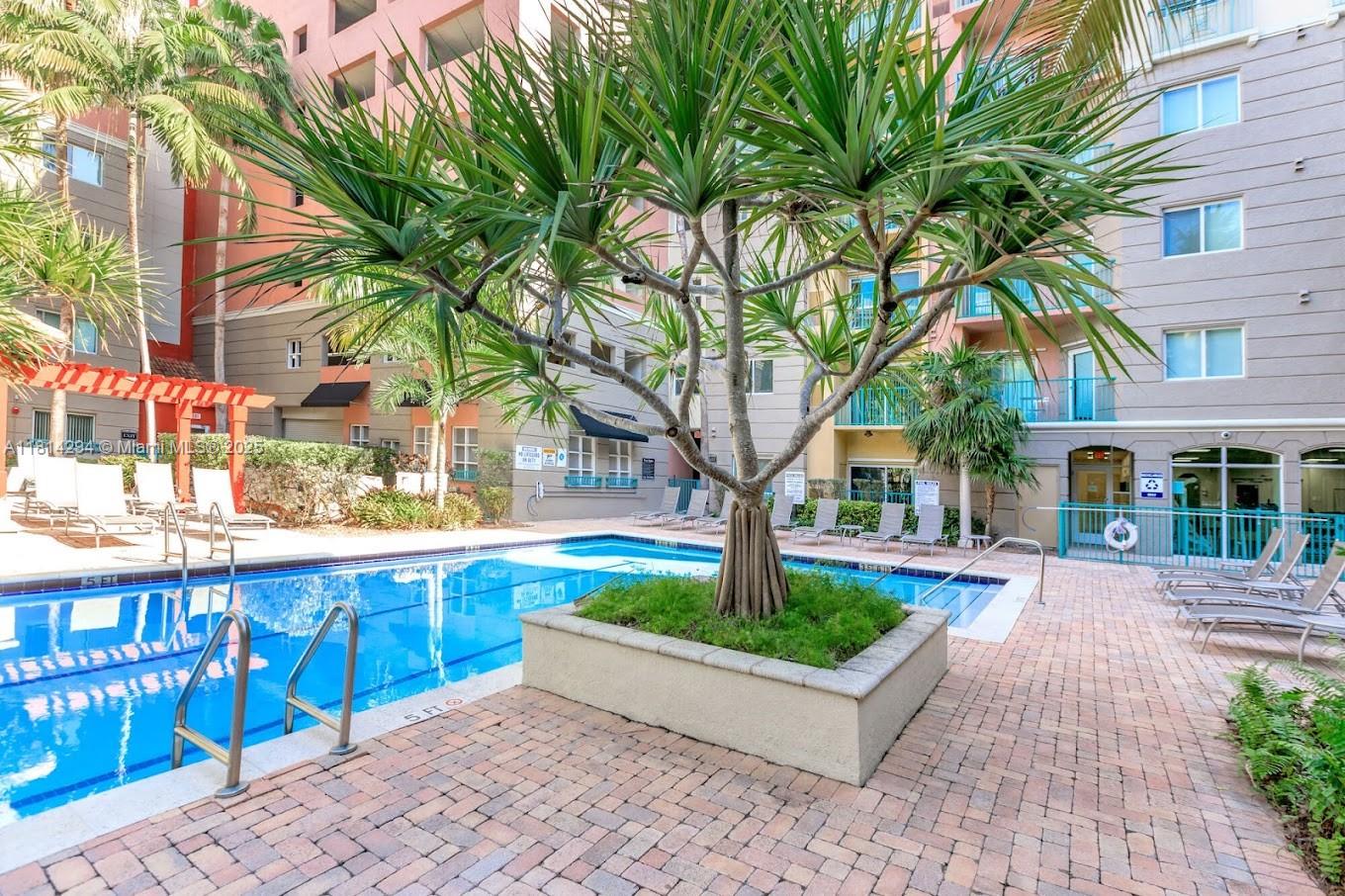 6001 Southwest 70th Street, Unit 252 South Miami, FL 33143 - Photo 4 of 15 a view of a building with a garden