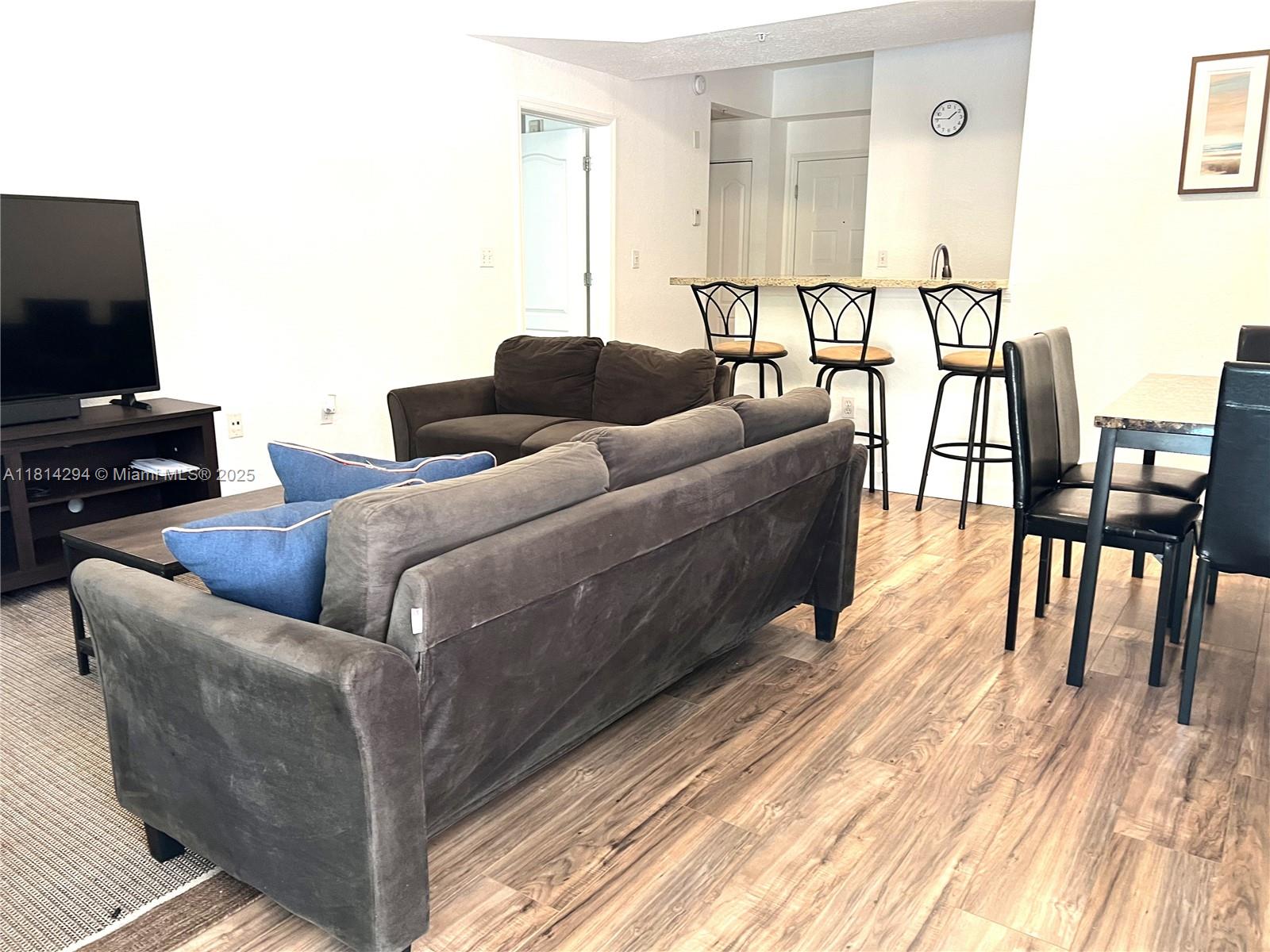 6001 Southwest 70th Street, Unit 252 South Miami, FL 33143 - Photo 8 of 15 a living room with furniture and a flat screen tv