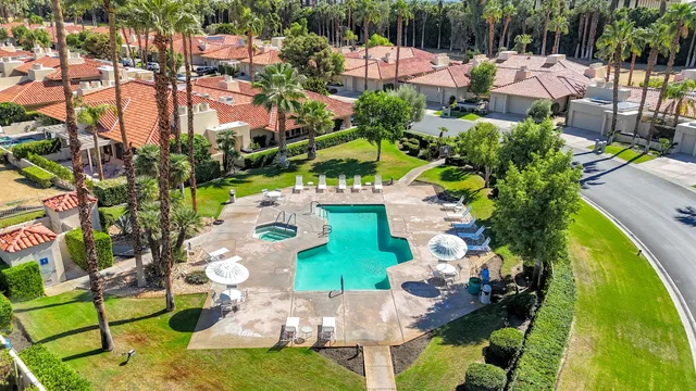 a aerial view of a house with a yard and lake view