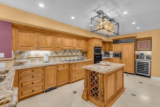 a kitchen with stainless steel appliances granite countertop a stove and cabinets