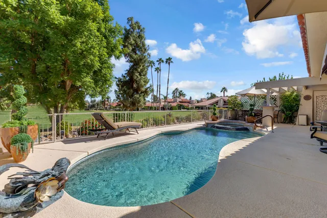 a view of a backyard with swimming pool