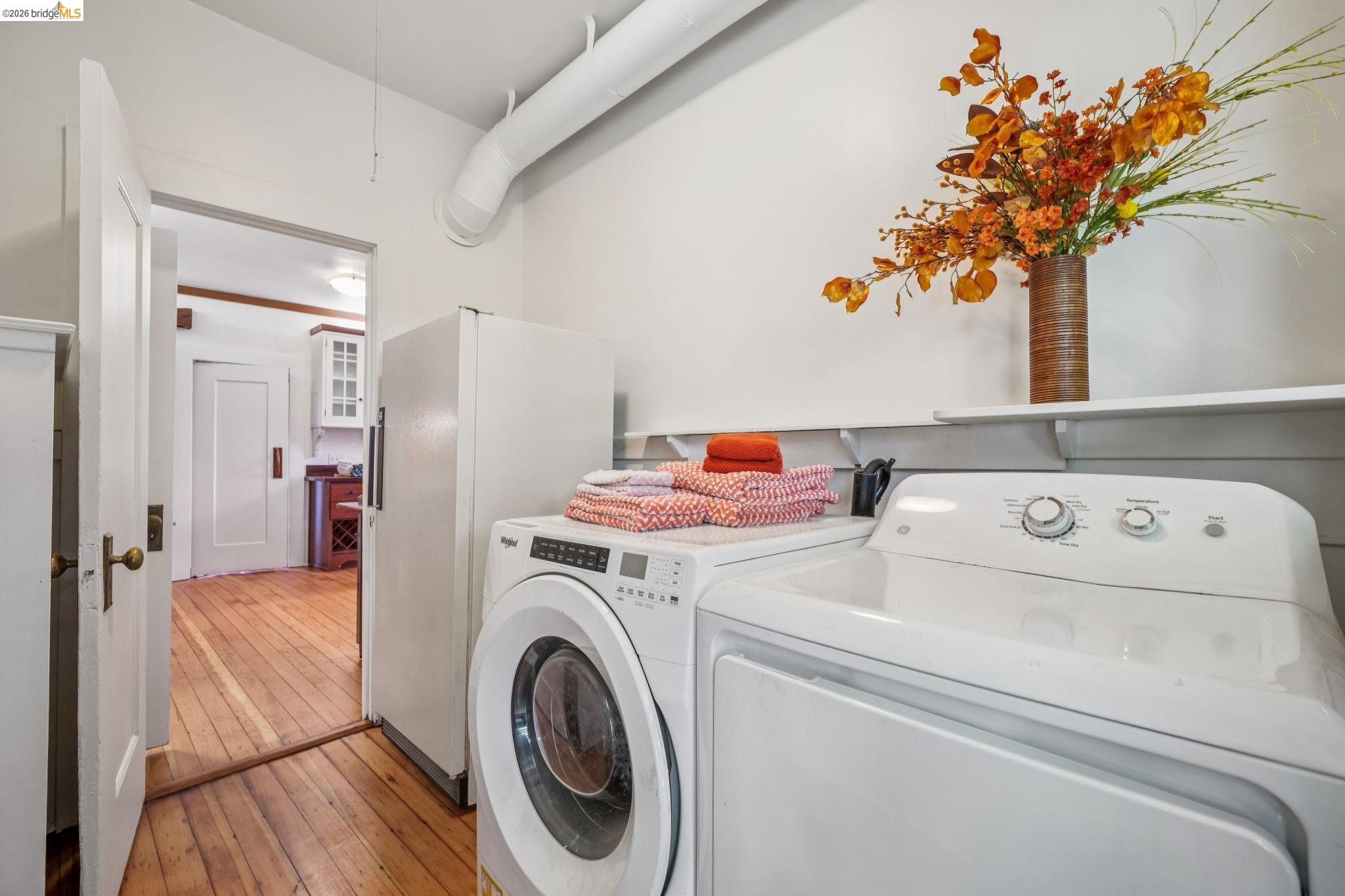 813 San Diego Road Berkeley, CA 94707 - Photo 25 of 60 a view of washer and dryer with kitchen in the background