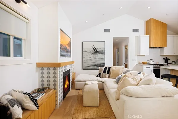 a living room with furniture fireplace and a flat screen tv