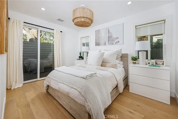 a spacious bedroom with a large bed and a large window