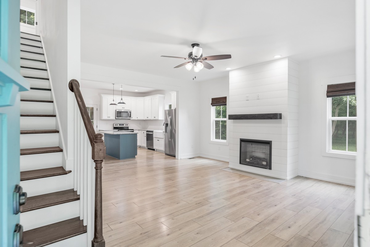 4486 Beards Chapel Road Springfield, TN 37172 - Photo 13 of 54 a view of a kitchen with a sink a fireplace and wooden floor