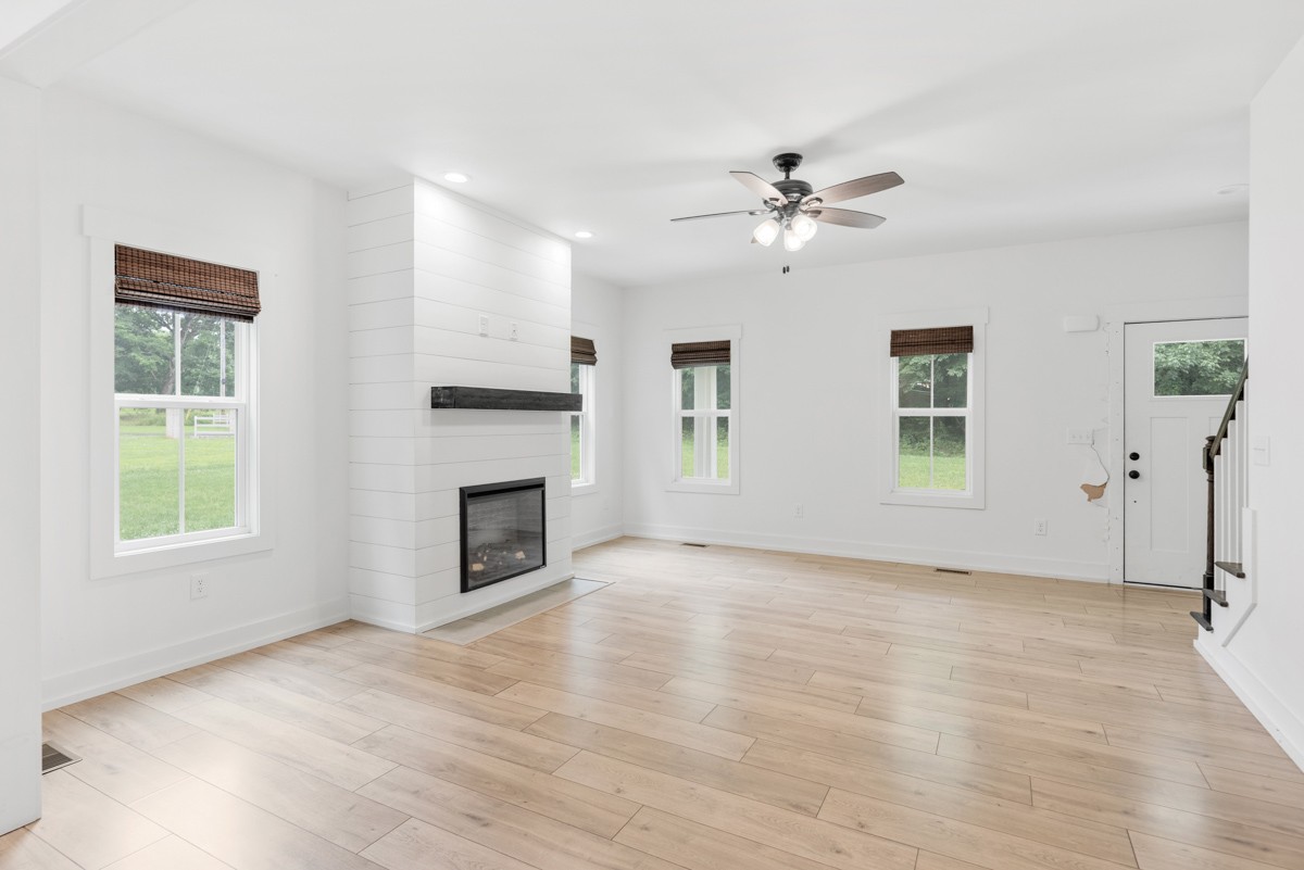 4486 Beards Chapel Road Springfield, TN 37172 - Photo 16 of 54 wooden floor fireplace and windows in an empty room