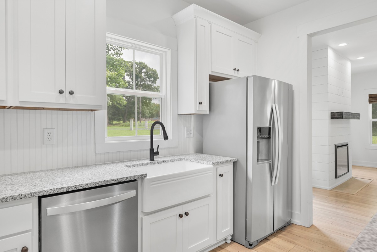 4486 Beards Chapel Road Springfield, TN 37172 - Photo 21 of 54 a kitchen with stainless steel appliances white cabinets and a window