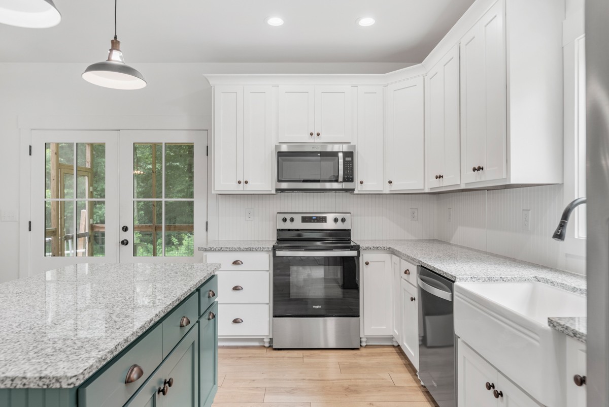 4486 Beards Chapel Road Springfield, TN 37172 - Photo 22 of 54 a kitchen with stainless steel appliances granite countertop a stove a sink and a microwave