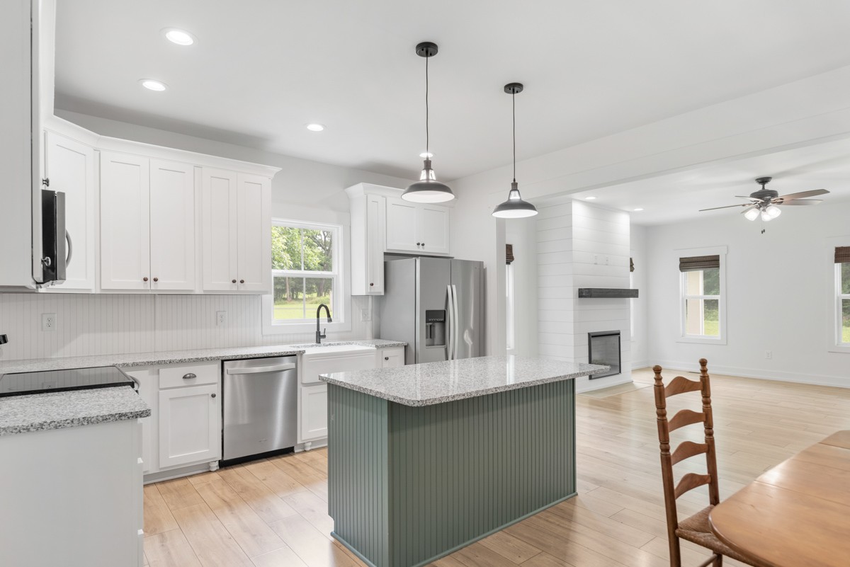 4486 Beards Chapel Road Springfield, TN 37172 - Photo 23 of 54 a kitchen with kitchen island granite countertop a sink cabinets and stainless steel appliances