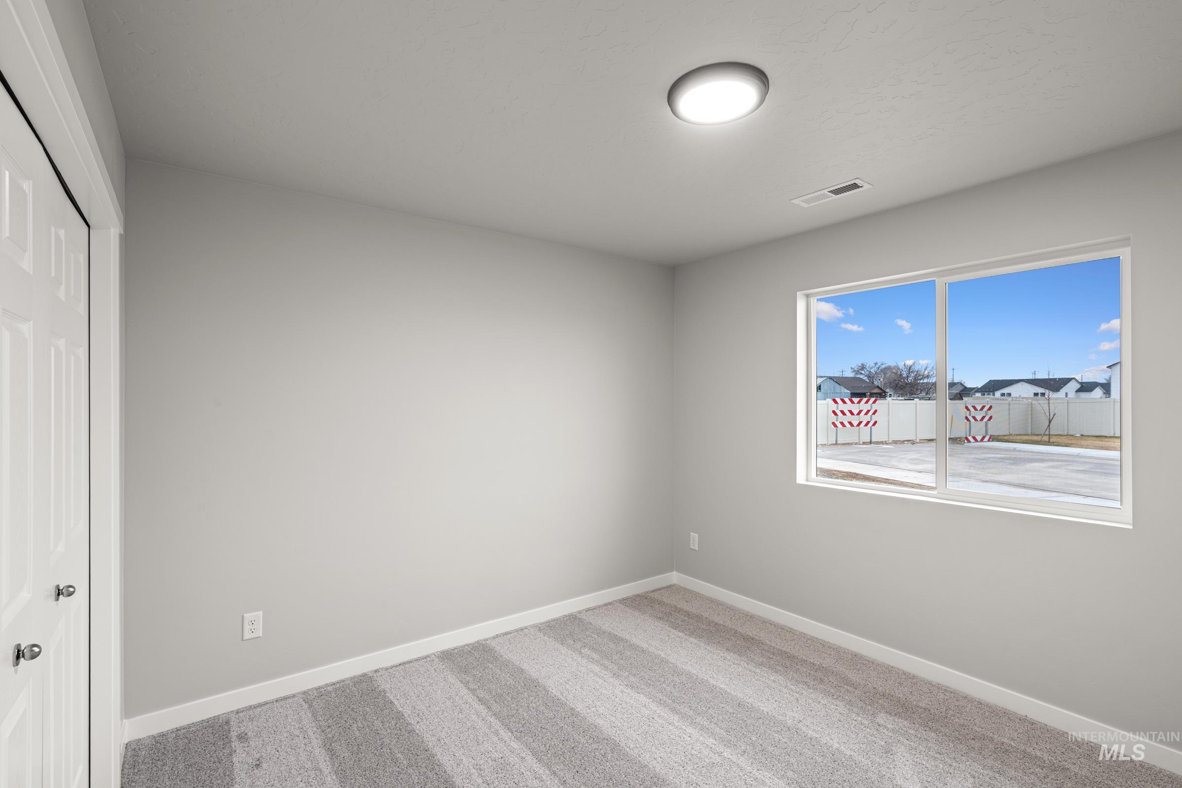 924 Northeast Trailridge Court Mountain Home, ID 83647 - Photo 12 of 21 Unfurnished bedroom featuring a closet and light colored carpet