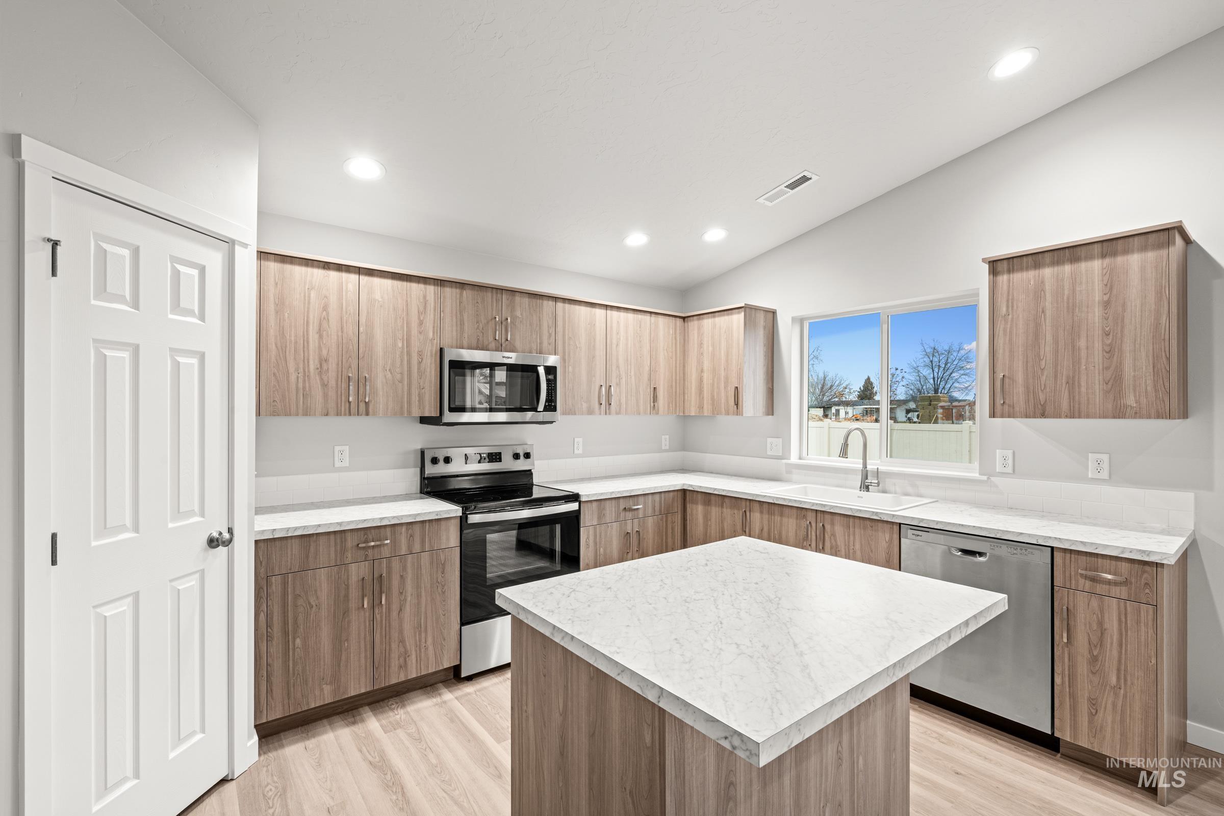 924 Northeast Trailridge Court Mountain Home, ID 83647 - Photo 4 of 21 Kitchen featuring stainless steel appliances, light countertops, modern cabinets, a center island, and light wood finished floors