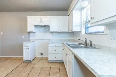 a kitchen with a sink cabinets and window