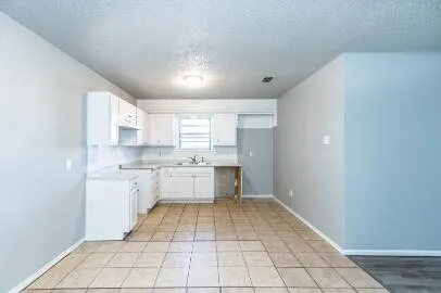 a kitchen with a white cabinets and white appliances