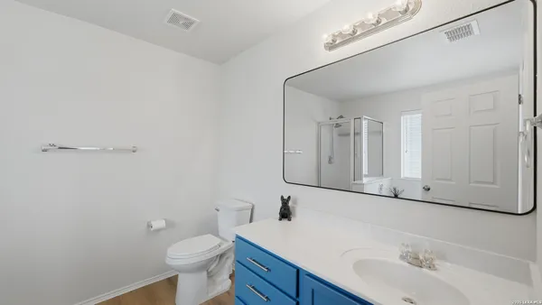 a bathroom with a sink a toilet and mirror