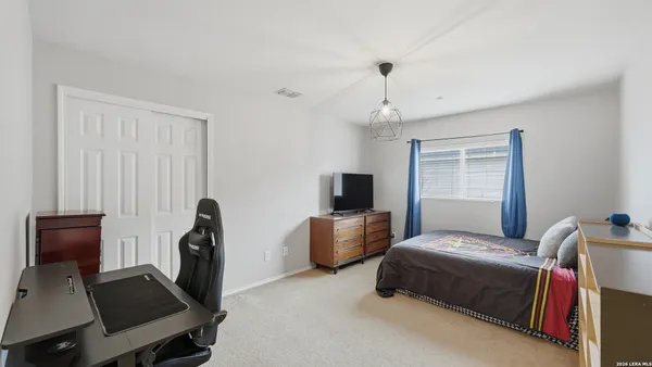 a bedroom with furniture and a window