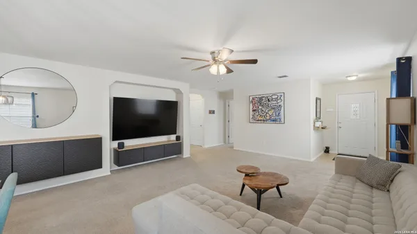a living room with furniture and a flat screen tv