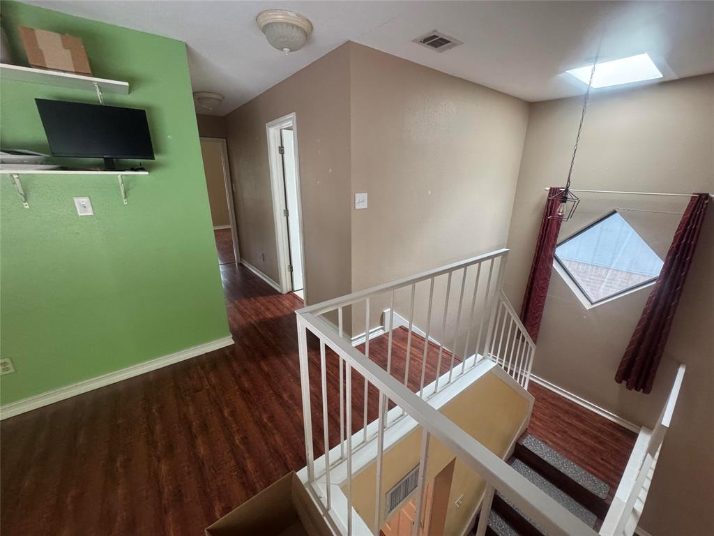4649 Misty Ridge Drive Fort Worth, TX 76137 - Photo 9 of 25 a view of a room with wooden floor and windows