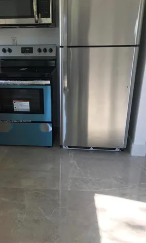 a kitchen with a stove and a refrigerator