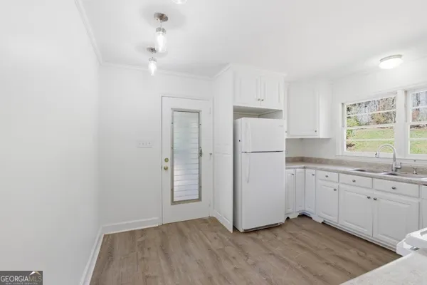 a view of a hallway with wooden floor