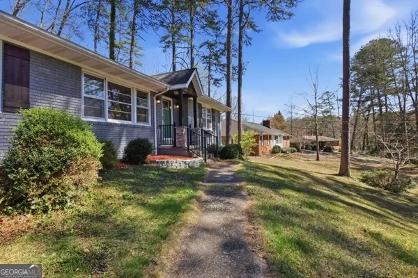 a view of a house with a yard and plants