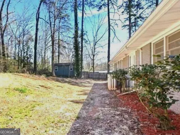a view of a house with a tree in the yard