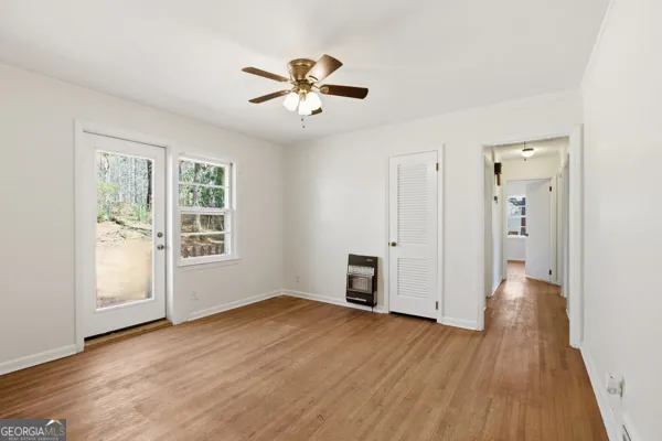 a kitchen with granite countertop a sink cabinets stainless steel appliances and a window