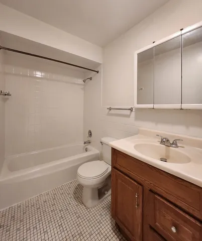 a bathroom with a sink toilet a mirror and shower
