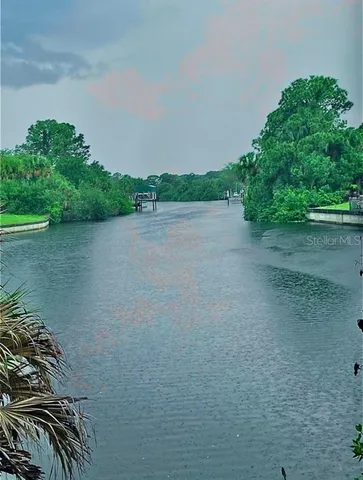 a lake view with boat and trees in the background