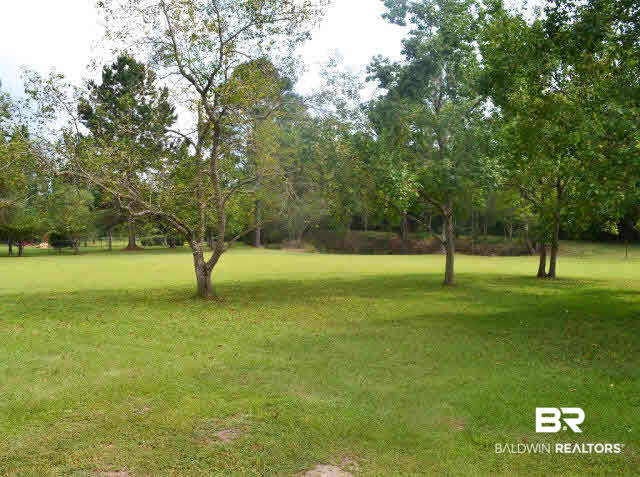 22700 Russian Road Gulf Shores, AL 36542 - Photo 15 of 25 Fenced in backyard with view of the pond.