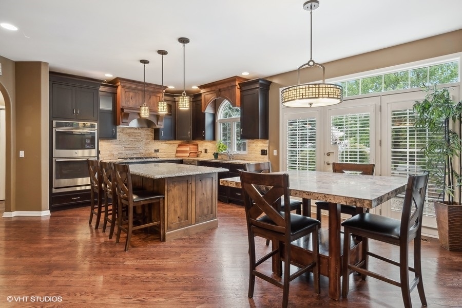 3179 Kingbird Lane Naperville, IL 60564 - Photo 17 of 52 a view of a dining room and livingroom with furniture wooden floor a chandelier