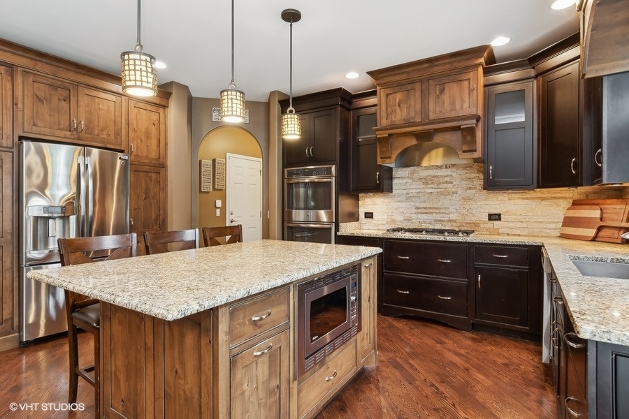 3179 Kingbird Lane Naperville, IL 60564 - Photo 19 of 52 a kitchen with stainless steel appliances granite countertop wooden cabinets a oven and a sink