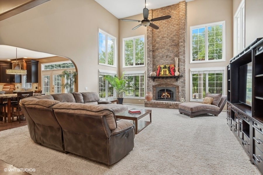3179 Kingbird Lane Naperville, IL 60564 - Photo 20 of 52 a living room with furniture a fireplace and a flat screen tv