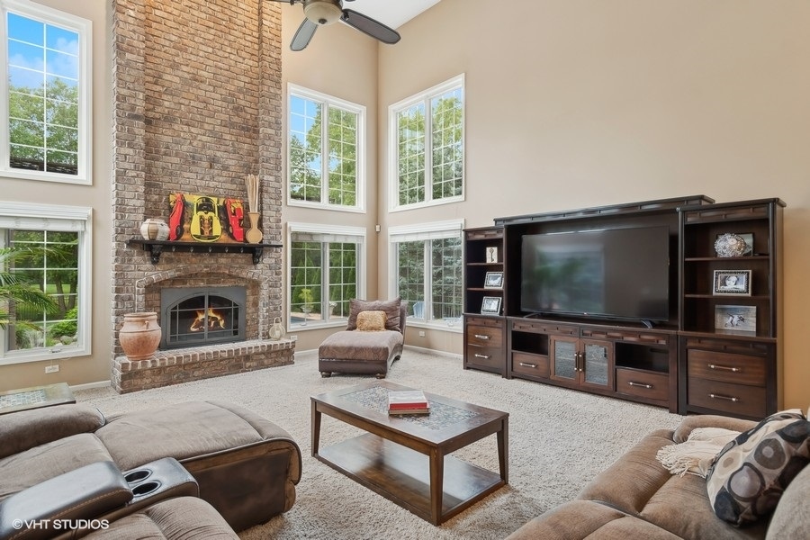 3179 Kingbird Lane Naperville, IL 60564 - Photo 21 of 52 a living room with furniture a flat screen tv and a fireplace