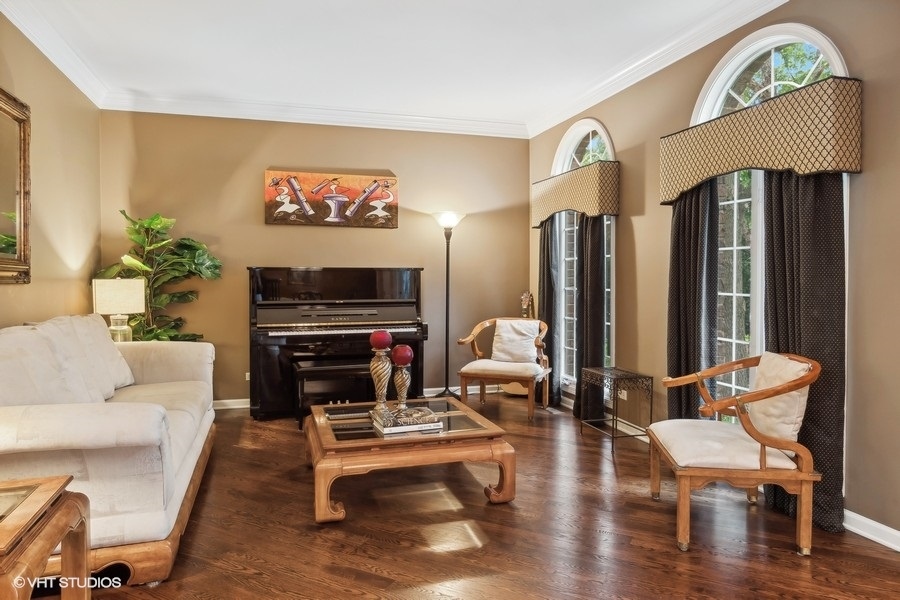 3179 Kingbird Lane Naperville, IL 60564 - Photo 25 of 52 a living room with furniture a fireplace and a flat screen tv