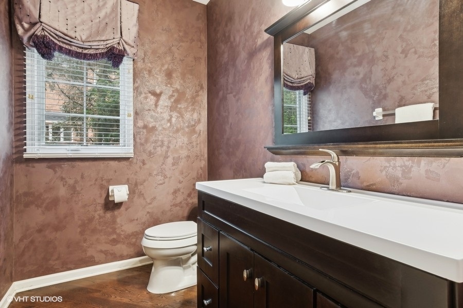 3179 Kingbird Lane Naperville, IL 60564 - Photo 31 of 52 a bathroom with a sink a toilet and a mirror