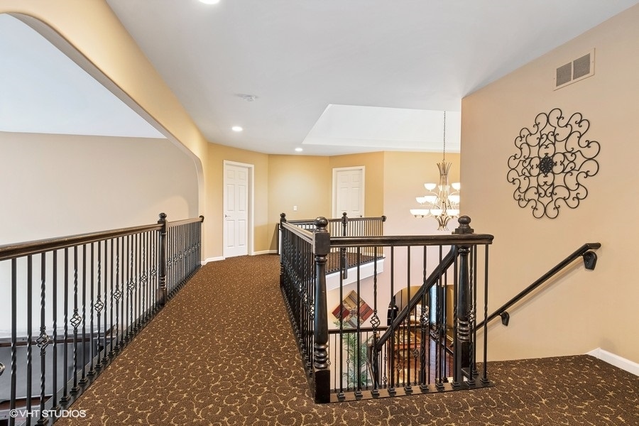 3179 Kingbird Lane Naperville, IL 60564 - Photo 33 of 52 a view of a hallway with wooden floor and stairs