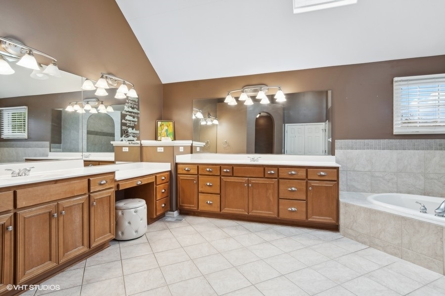 3179 Kingbird Lane Naperville, IL 60564 - Photo 36 of 52 a spacious bathroom with a granite countertop double vanity sink mirror and bathtub