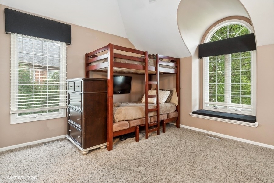 3179 Kingbird Lane Naperville, IL 60564 - Photo 40 of 52 a bedroom with a bunk bed and a window