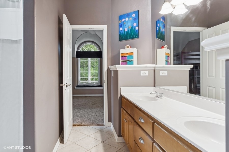 3179 Kingbird Lane Naperville, IL 60564 - Photo 42 of 52 a bathroom with a sink a vanity and a mirror