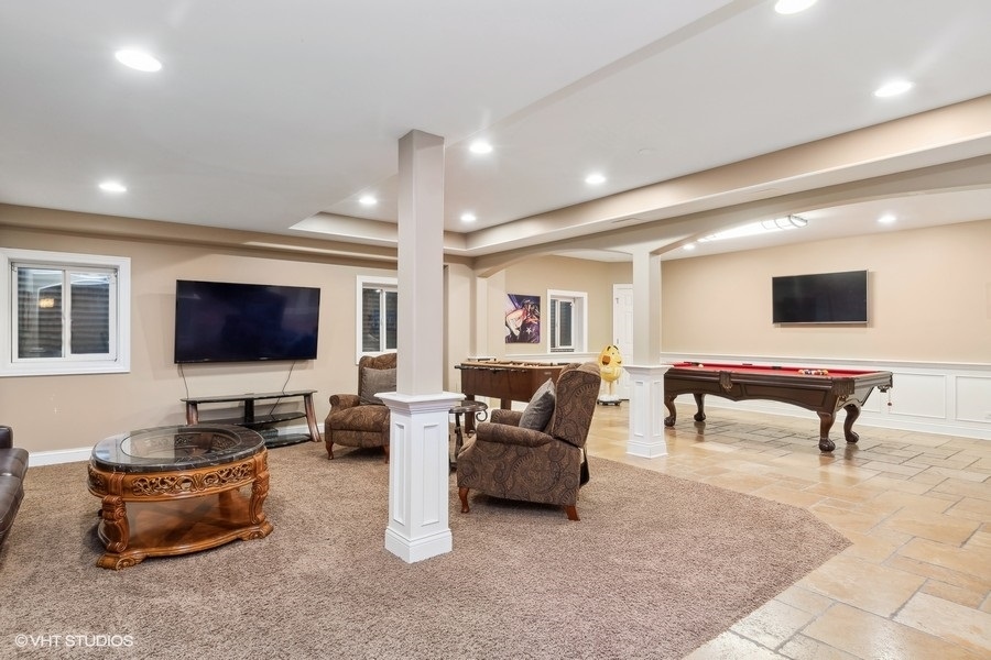 3179 Kingbird Lane Naperville, IL 60564 - Photo 44 of 52 a living room with furniture and a flat screen tv