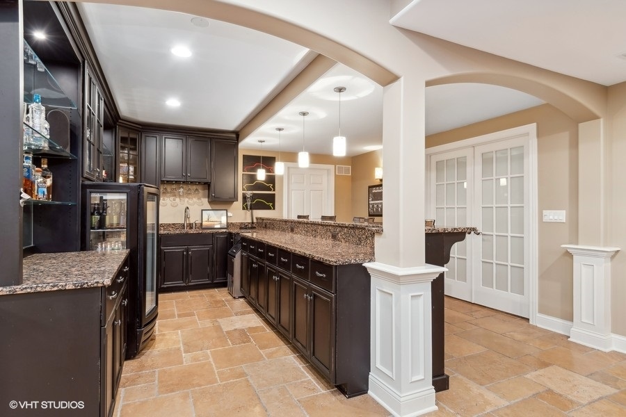 3179 Kingbird Lane Naperville, IL 60564 - Photo 46 of 52 a large kitchen with stainless steel appliances kitchen island granite countertop a large counter top and a view of living room