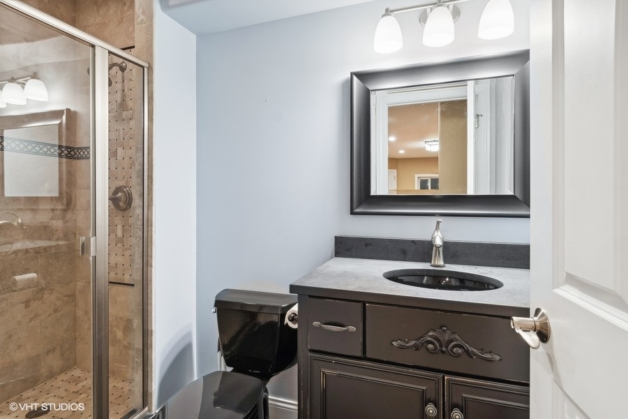 3179 Kingbird Lane Naperville, IL 60564 - Photo 48 of 52 a bathroom with a sink and a mirror