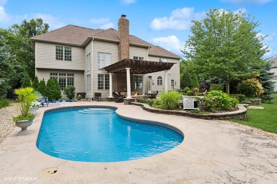 3179 Kingbird Lane Naperville, IL 60564 - Photo 8 of 52 a view of a house with pool plants and large trees