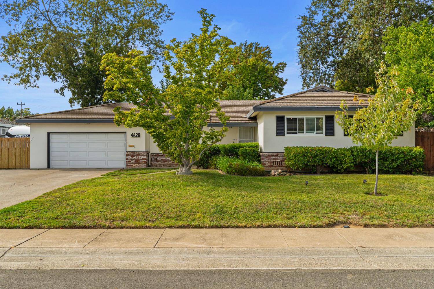 a front view of a house with a yard and a garage