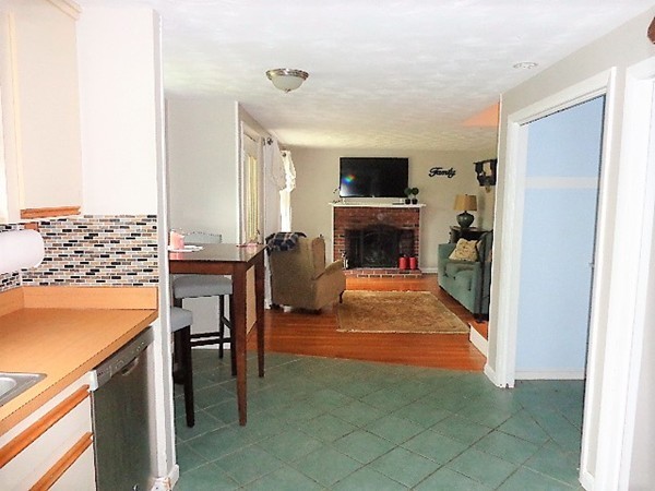 10 Sylvan Road Holbrook, MA 02343 - Photo 9 of 23 a living room with furniture a flat screen tv and a fireplace
