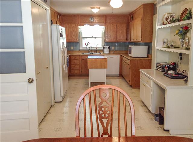 1186 Pleasant Ridge Road Goodspring, TN 38460 - Photo 14 of 20 a kitchen with stainless steel appliances a refrigerator a sink a stove and white cabinets