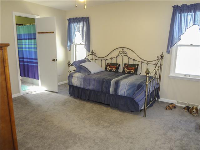 1186 Pleasant Ridge Road Goodspring, TN 38460 - Photo 17 of 20 a bedroom with a bed next to a window