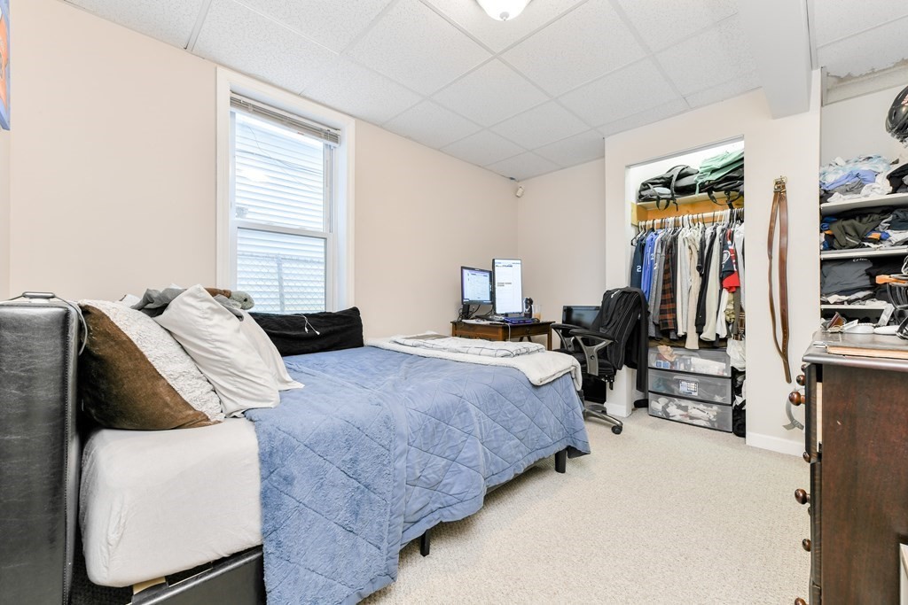 748 East 3rd Street, Unit A Boston, MA 02127 - Photo 8 of 16 a bedroom with bed and walk in closet
